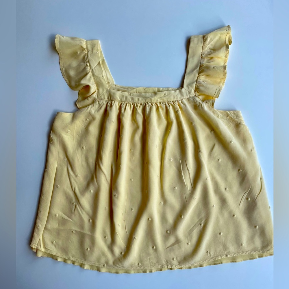 Francesca’s light yellow camisole.